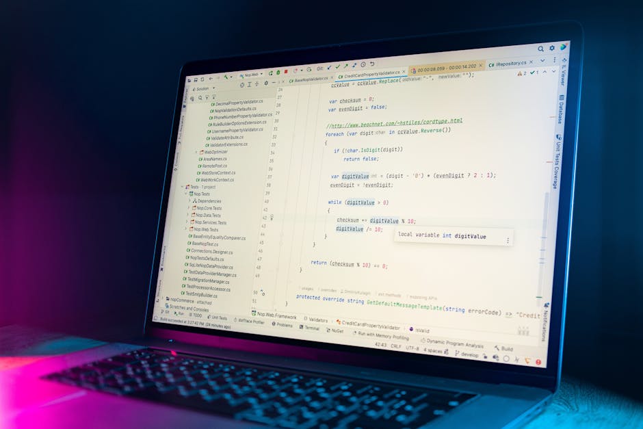 A close-up view of a laptop computer screen displaying lines of programming code in a text editor. The code includes various syntax elements such as variables, comments, and functions, primarily writt