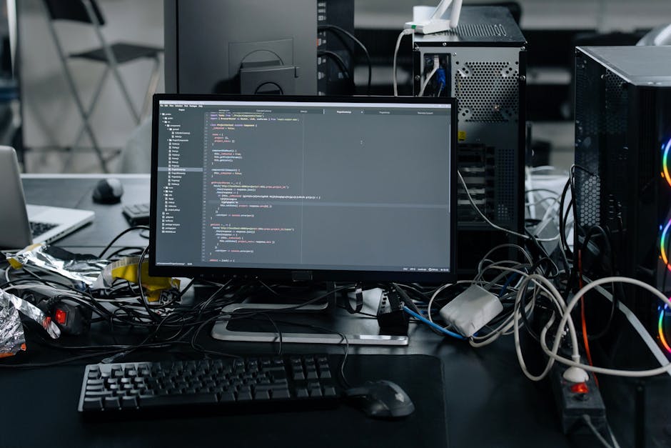 A close-up view of a laptop computer screen displaying lines of programming code in a text editor. The code includes various syntax elements such as variables, comments, and functions, primarily writt